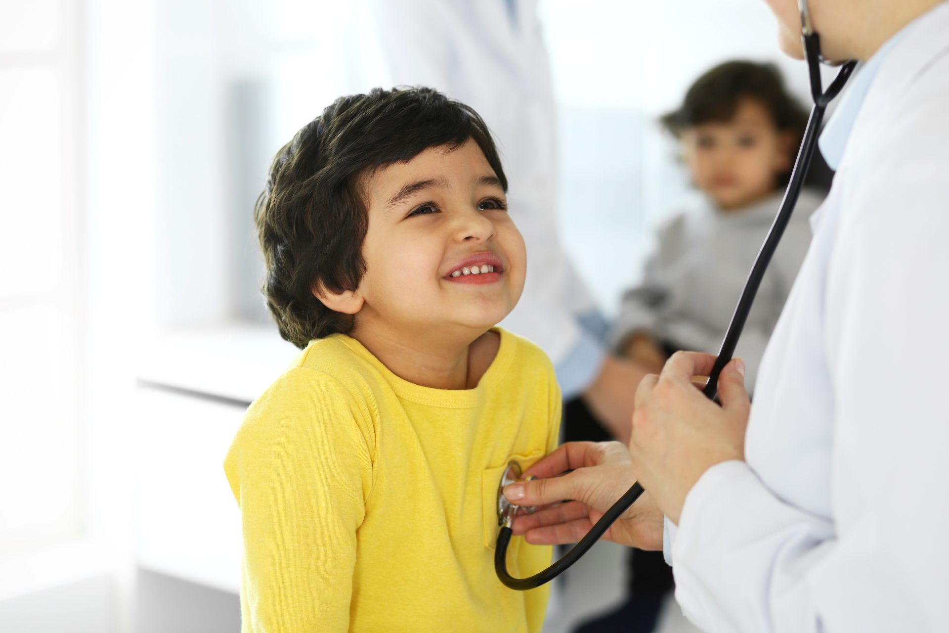 child with parent and medical provider for pediatric urgent care services