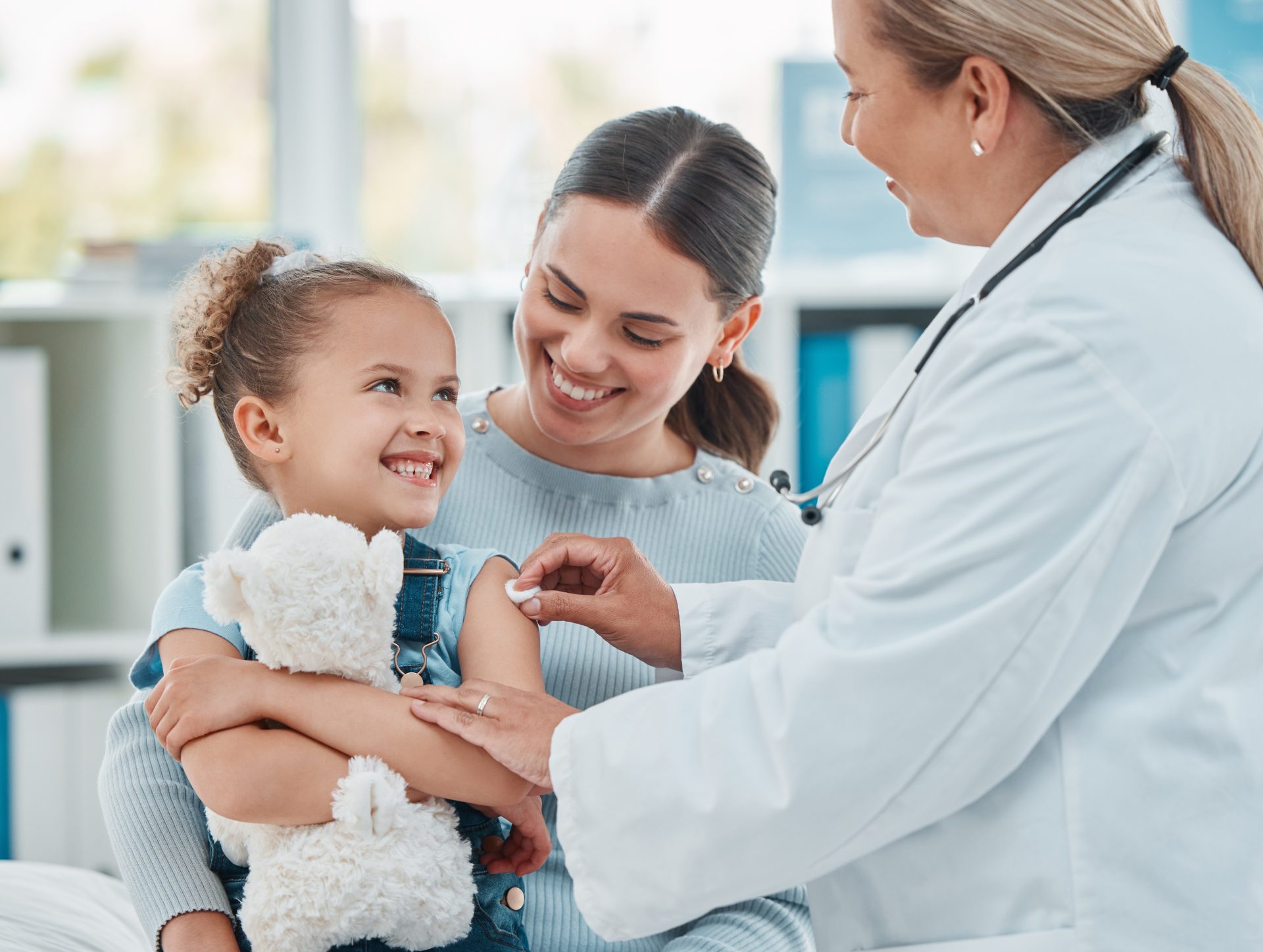 child with parent and medical provider for pediatric urgent care services