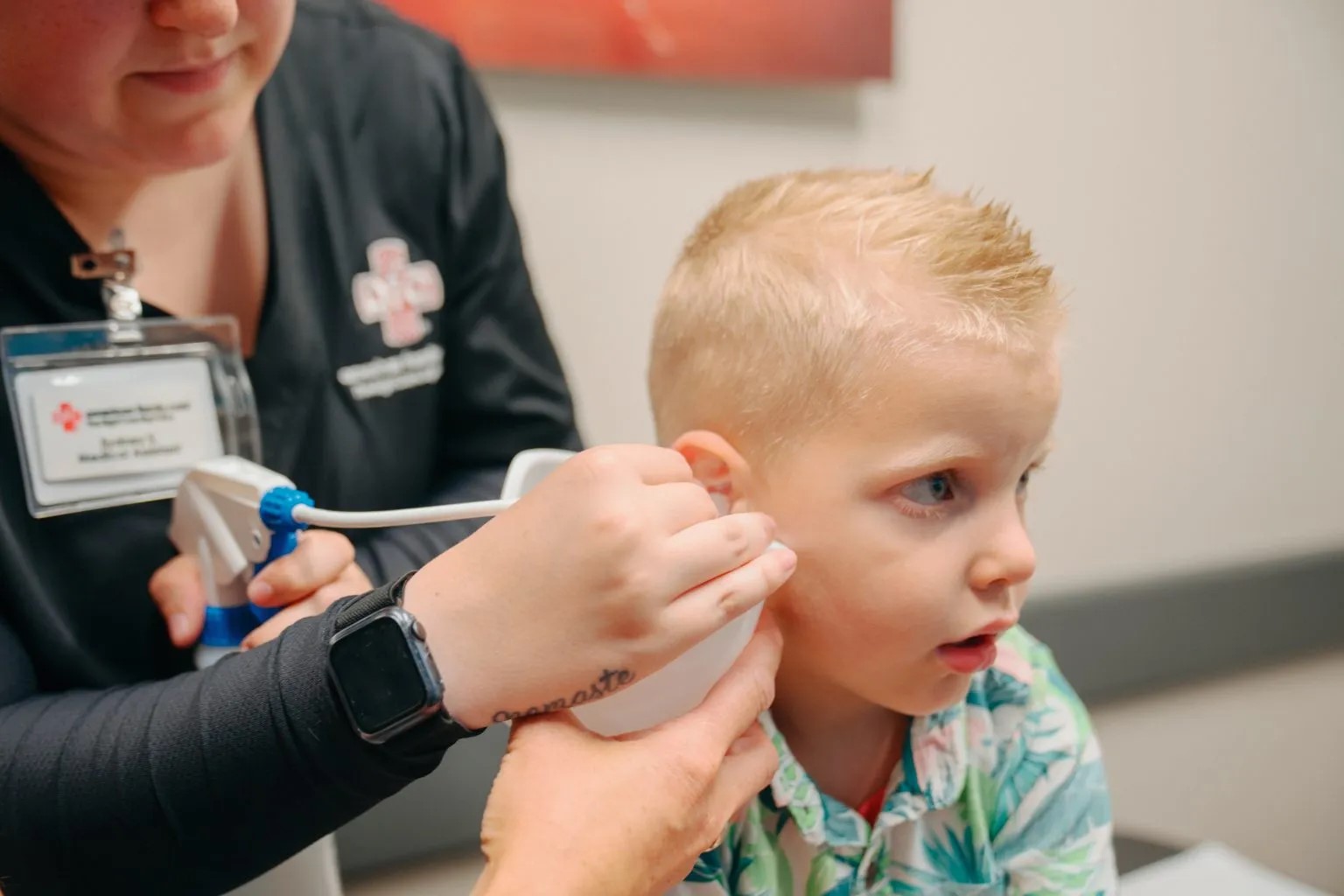 Provider cleaning child's ear at AFC Fort Collins