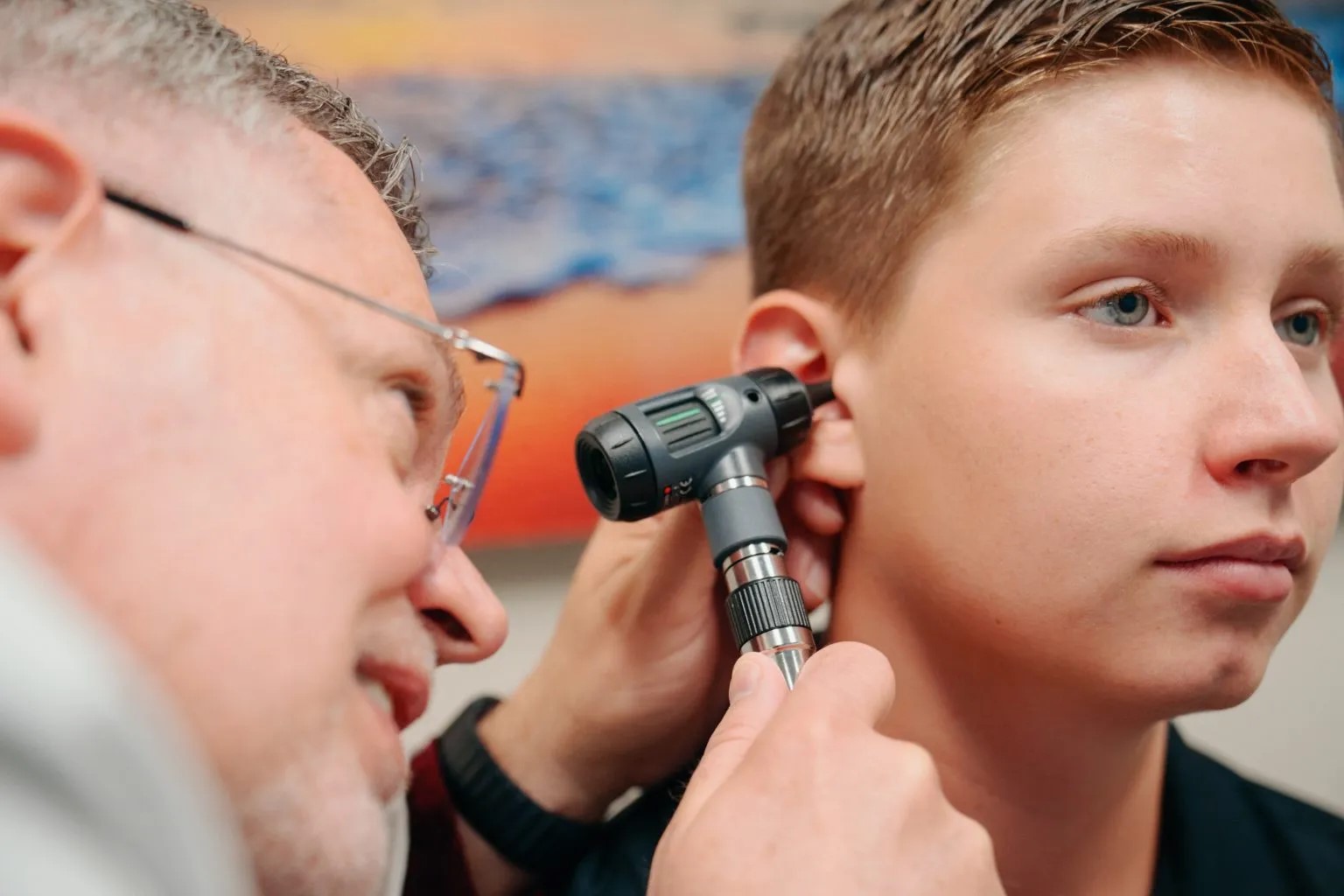 Medical provider examining patient's ear for an ear infection at AFC Fort Collins