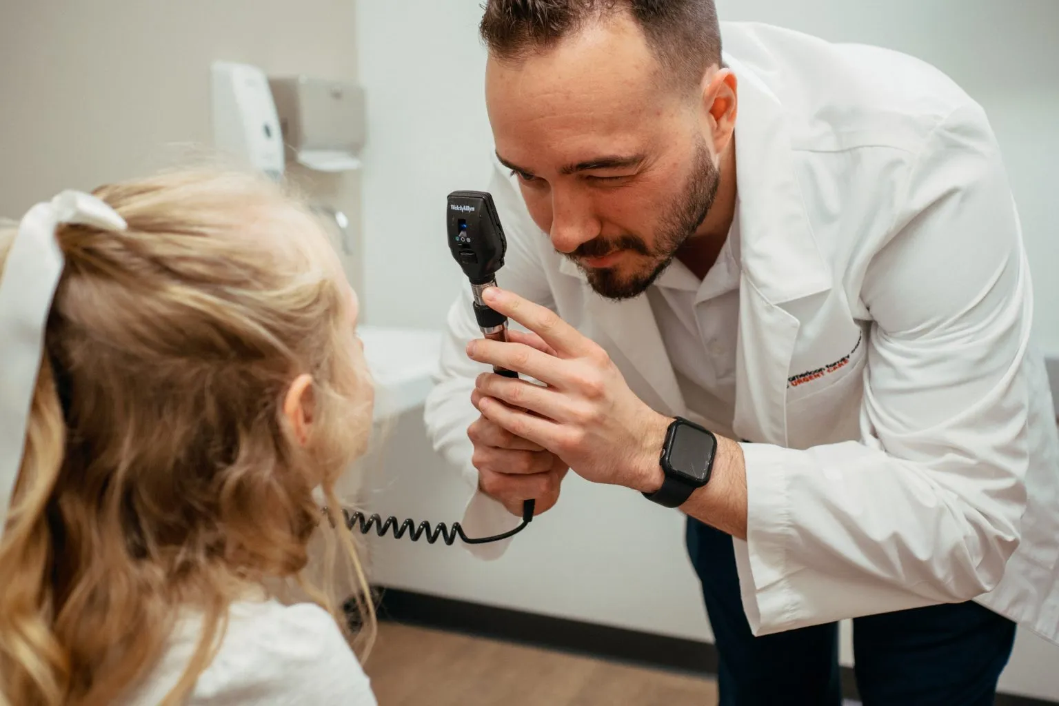 AFC provider examining child patient