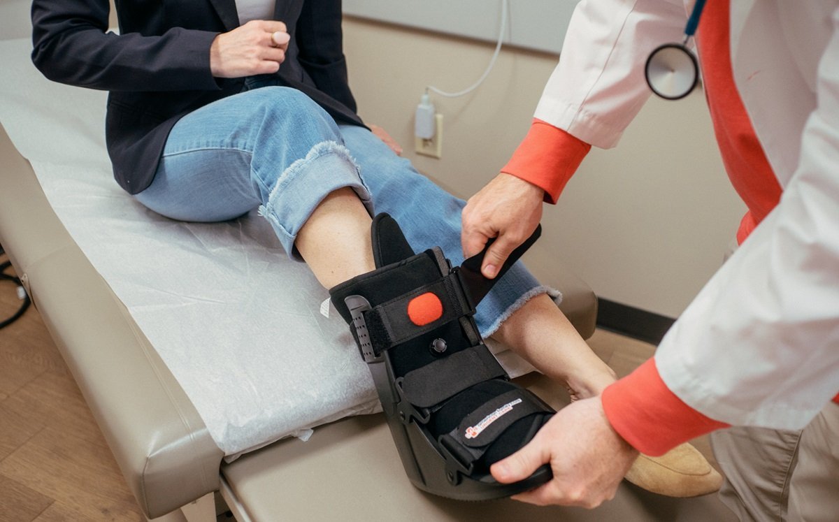 Medical provider examining patient's ankle injury