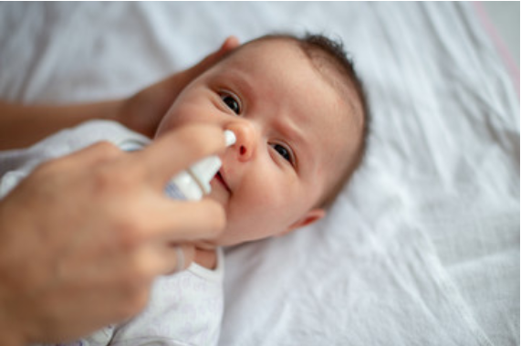 An infant receiving care for flu and RSV symptoms at AFC Urgent Care Natick during flu season.