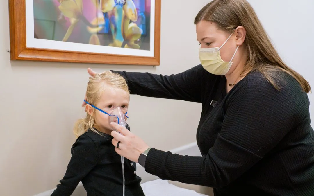 Child receiving breathing treatment for asthma at AFC