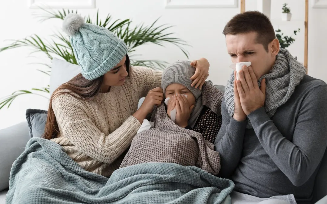 Mother comforts sick son and husband blowing their noses