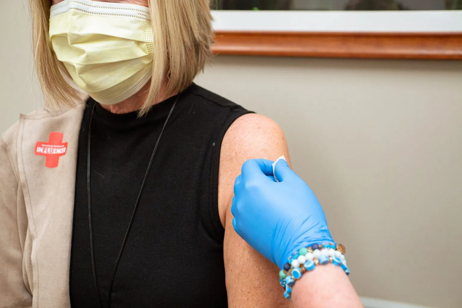 Lady at AFC getting a prepared to get a flu shot.